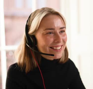 Female with specs talking on phone
