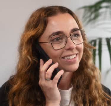 Female with specs talking on phone