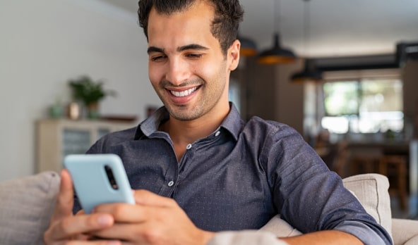 Man using phone and smiling