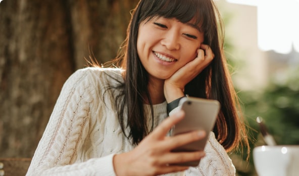 Woman looking at phone smiling