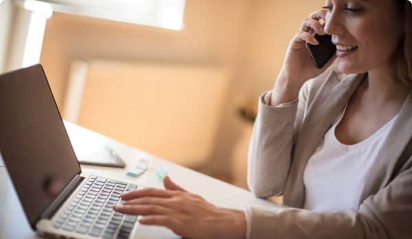 Women on phone using laptop
