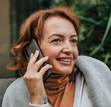 Man wearing a shirt talking over phone