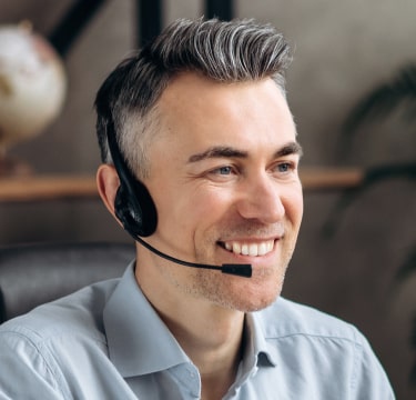 Male virtual receptionist on call, smiling and ready to assist with a friendly and professional demeanor.