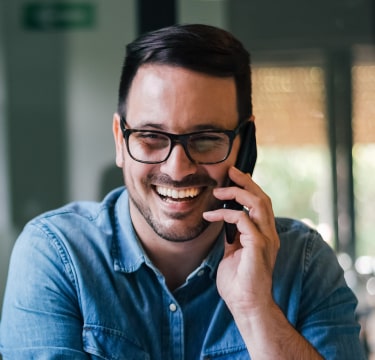 Man talking on phone and laughing