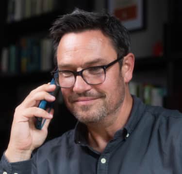 Man talking on phone and smiling