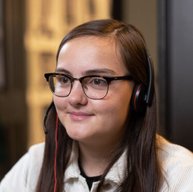 Smiling women wearing glasses and headset