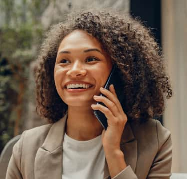 Smiling virtual receptionist touching headset